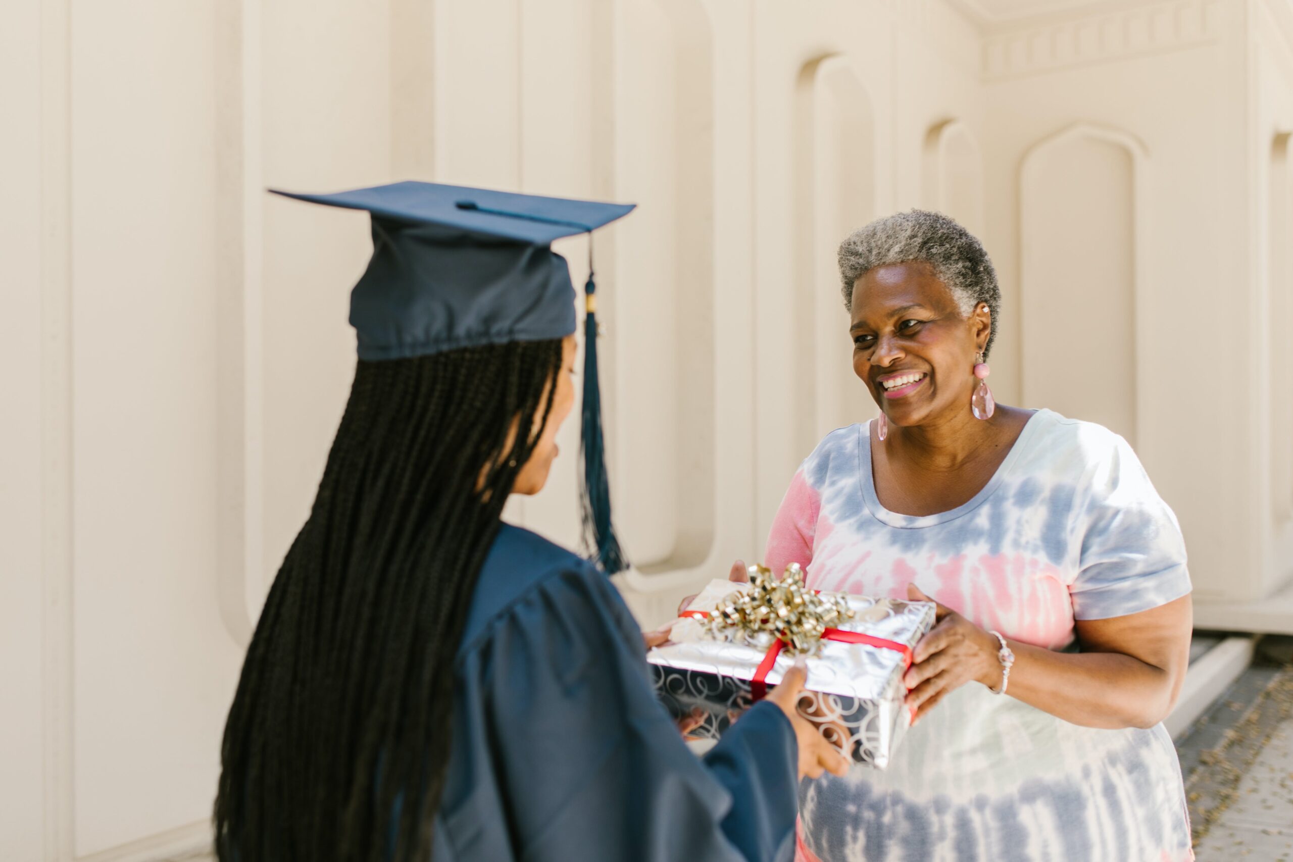 A mother gives her daughter a graduation gift.